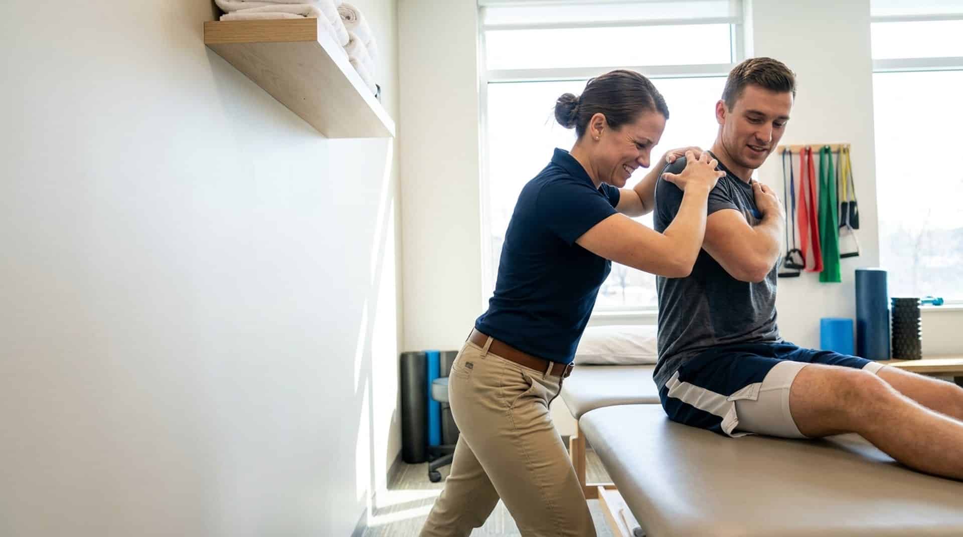 Therapist assisting a patient with shoulder mobility work